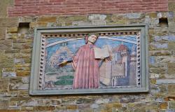 Plaque depicting Dante on a wall in the streets of Florence