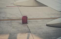 A lone lost suitcase on a runway in Rome