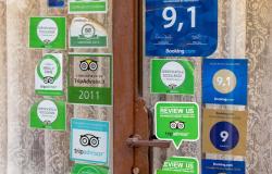 Tripadvisor rating stickers and other decals on a restaurant window