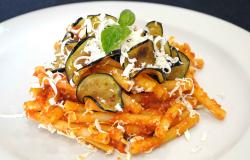Pasta alla Norma dish with tomato sauce eggplant and basil