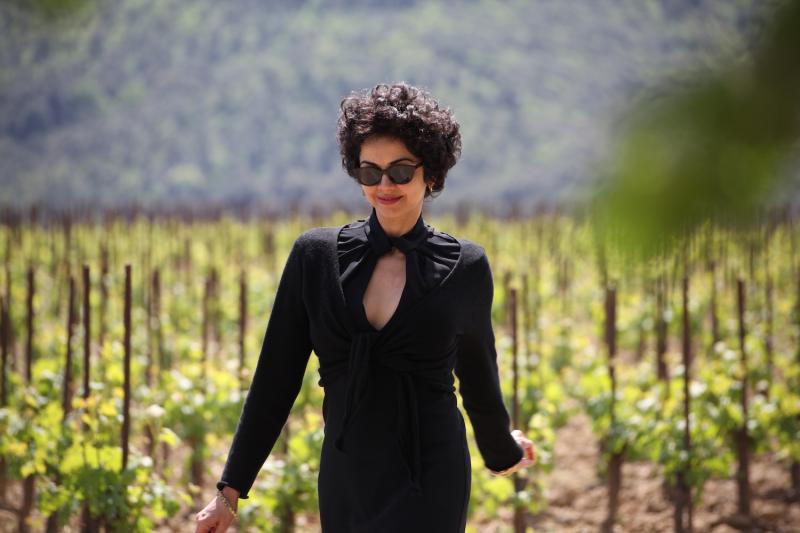 kamin mohammadi, author of bella figura, standing in vineyard in black dress