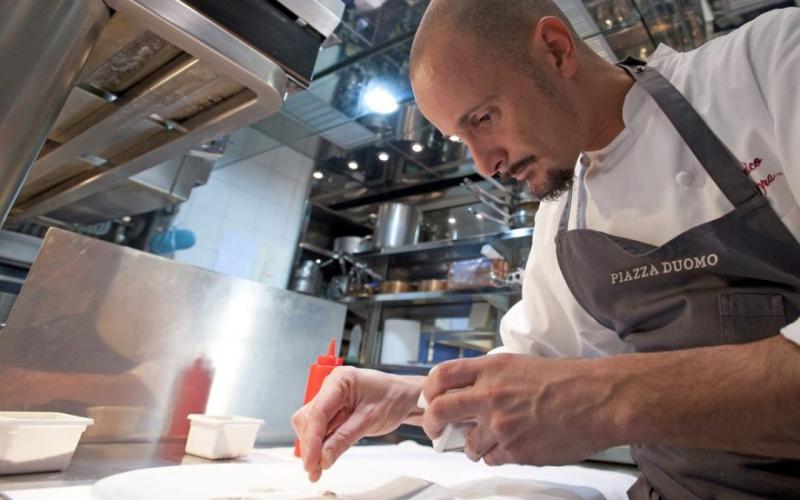 Chef Enrico Crippa working in the kitchen at Piazza Duomo in Alba Italy